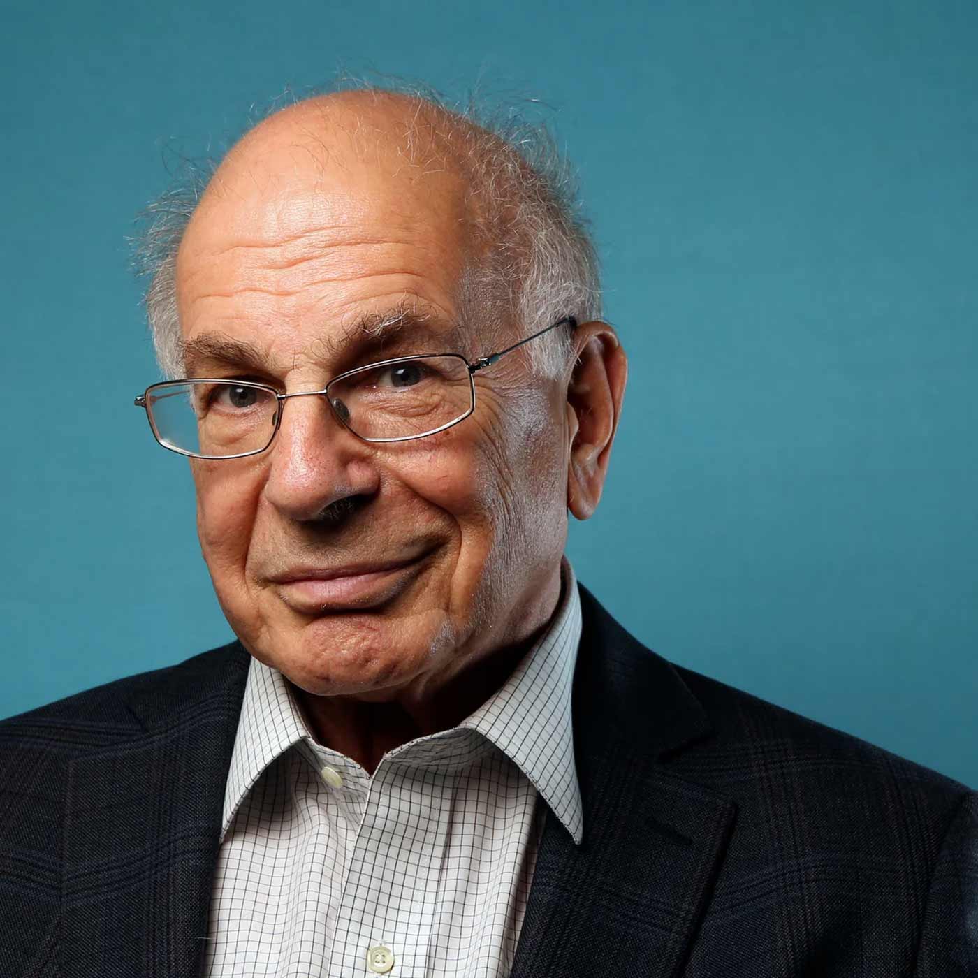 Daniel Kahneman photographed on a blue aqua background